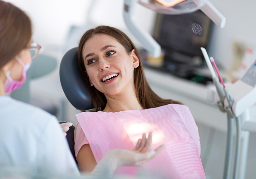 Female patient leaning back in chair and smiling