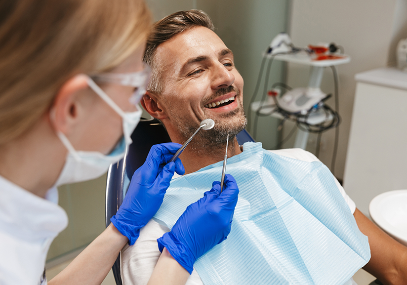 Man sitting back in dental chair and smiling