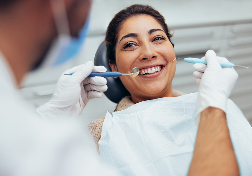 Woman in dental chair having teeth examined