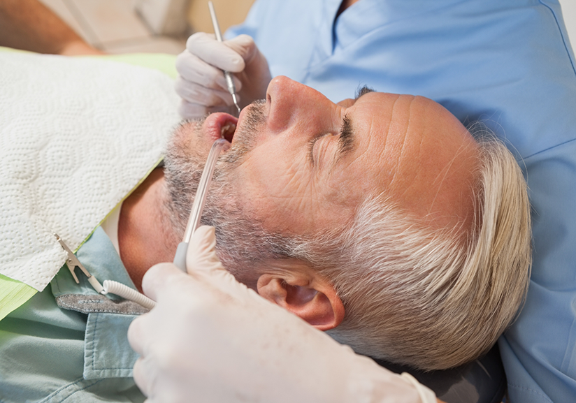 Close-up of male patient during teeth cleaning