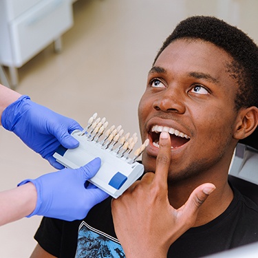 Male patient pointing to a tooth