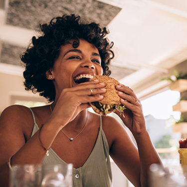 Woman about to eat a burger