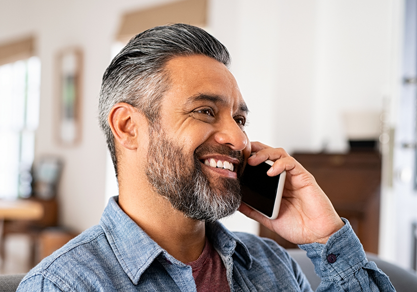 Bearded man talking on phone and smiling