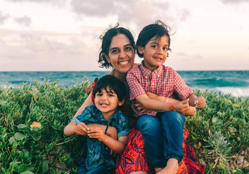 Pantego dentist Dr. Shah sitting in grass with her kids