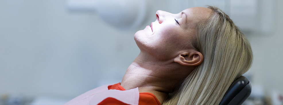 Woman in dental chair sitting back and relaxing