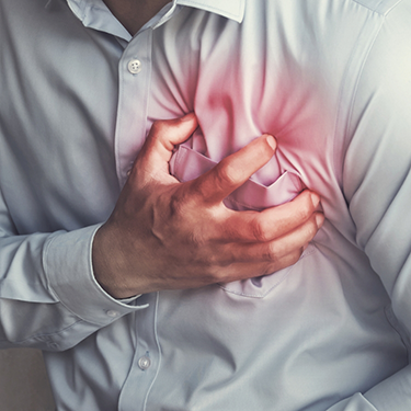 Man with heart problems clutching chest