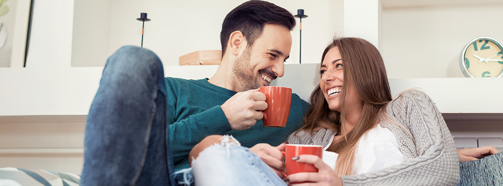 Man and woman on couch with cups